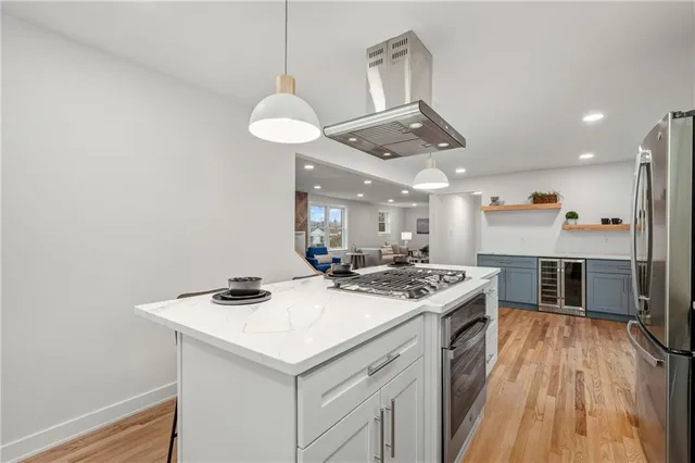 a kitchen with a stove a counter space a sink and appliances