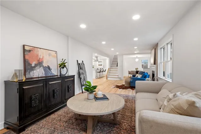 a living room with furniture a flat screen tv and a dining table