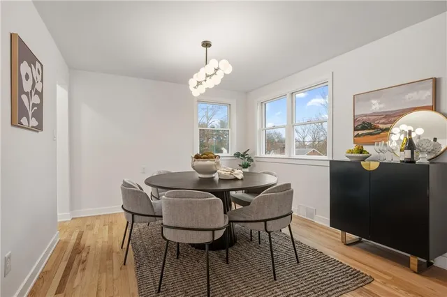 a view of a dining room with furniture wooden floor and chandelier