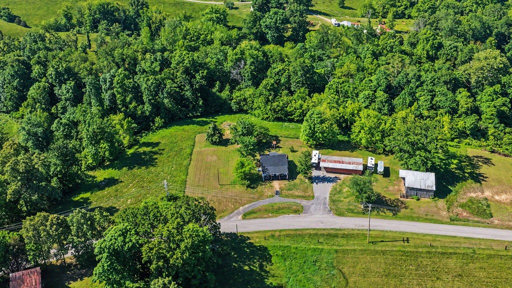 175 Gentry Gray Road Cadiz, KY 42211 - Photo 42 of 46 an aerial view of a house with a garden and trees