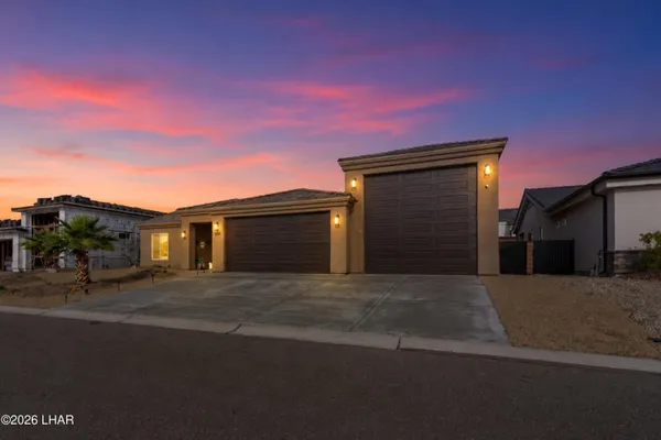 a front view of a house with a yard and garage