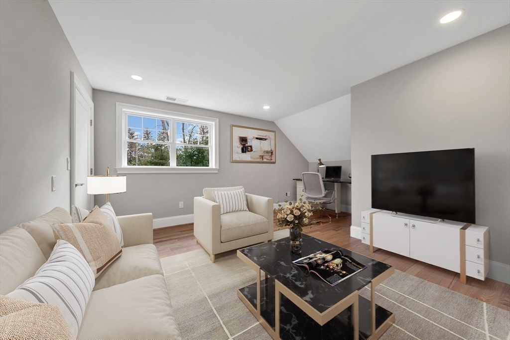 30 Weber Farm Road, Unit 30 Wrentham, MA 02093 - Photo 24 of 31 a living room with furniture a flat screen tv and a window