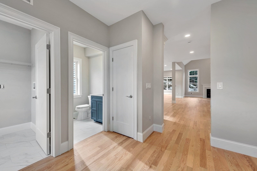 30 Weber Farm Road, Unit 30 Wrentham, MA 02093 - Photo 4 of 31 a view of a hallway with wooden floor and a bathroom