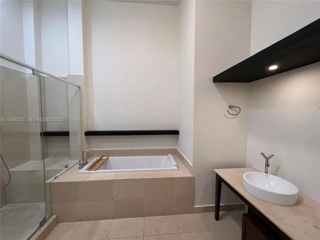 a bathroom with a tub and a shower