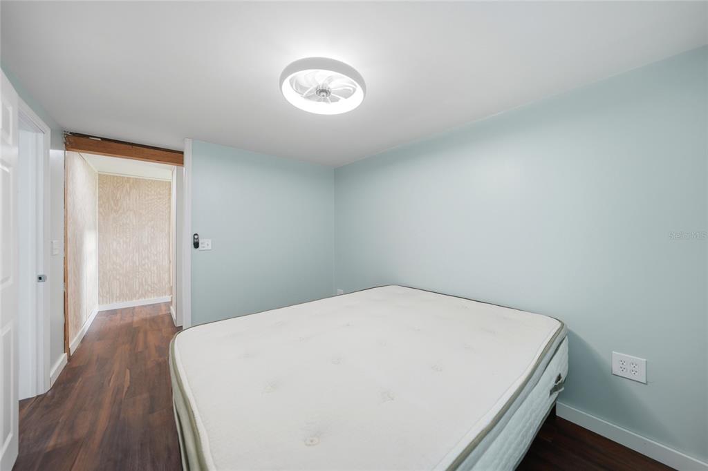 8164 Archie Street Englewood, FL 34224 - Photo 17 of 42 a view of a room with wooden floor and a ceiling fan