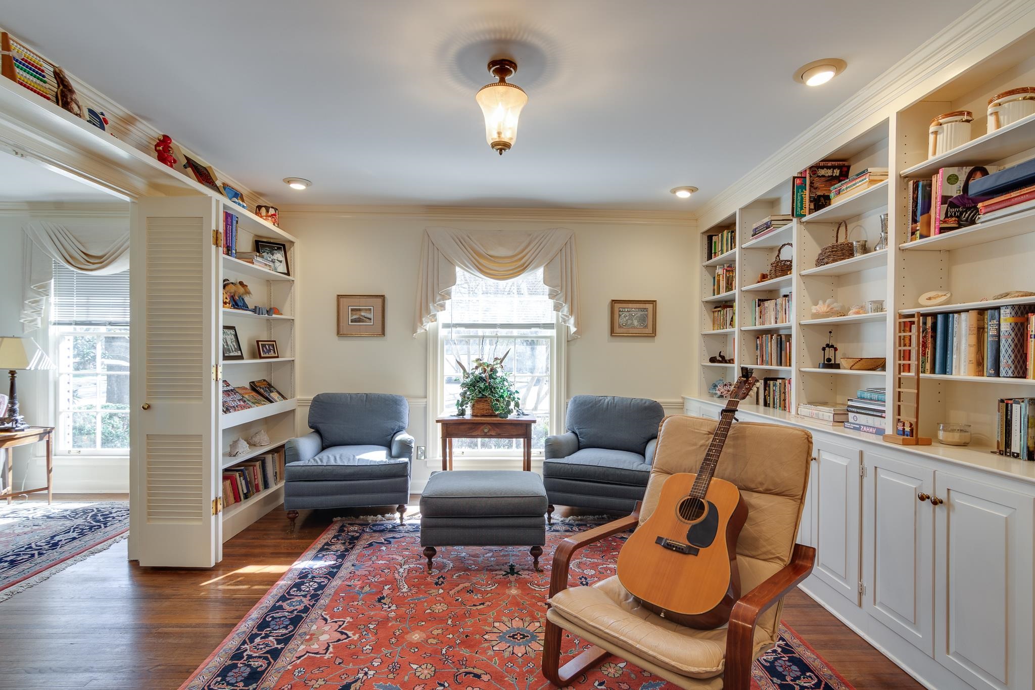 199 South Grove Park Road Memphis, TN 38117 - Photo 8 of 40 Living area featuring built in shelves, dark wood-style flooring, and crown molding