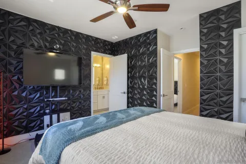 a bedroom with a bed and a chandelier