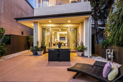 a view of a house with backyard and sitting area