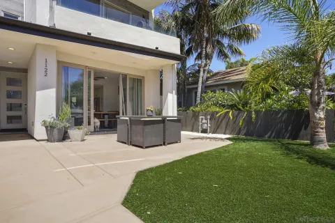 a kitchen with granite countertop a stove a refrigerator and wooden floors
