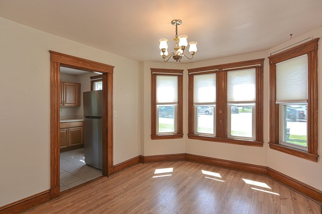 228 Pond Street Natick, MA 01760 - Photo 11 of 36 a view of an empty room with wooden floor and a window