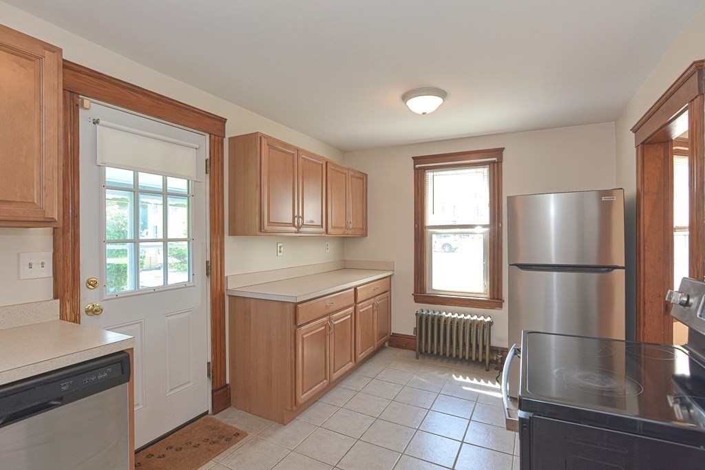 228 Pond Street Natick, MA 01760 - Photo 13 of 36 a kitchen with a refrigerator a stove a sink and a window