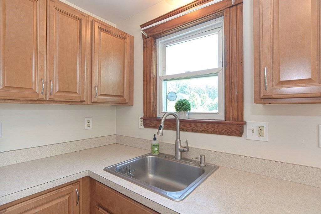 228 Pond Street Natick, MA 01760 - Photo 14 of 36 a kitchen with stainless steel appliances granite countertop a sink and a window