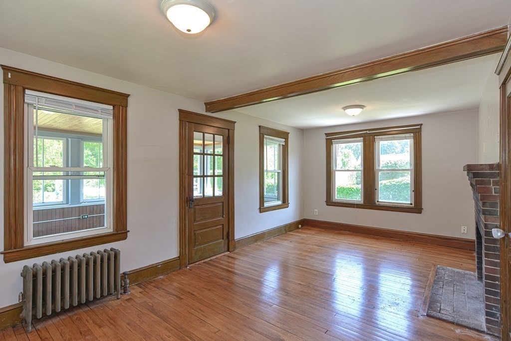 228 Pond Street Natick, MA 01760 - Photo 17 of 36 a view of an empty room with wooden floor and a window