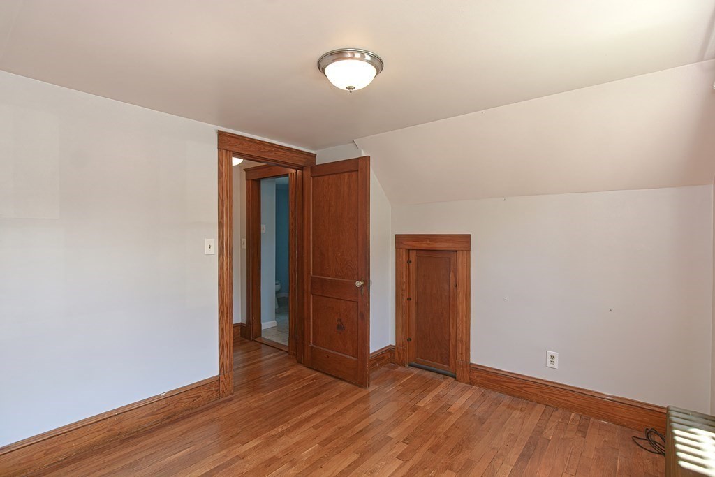 228 Pond Street Natick, MA 01760 - Photo 24 of 36 a view of an empty room with wooden floor