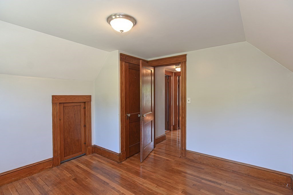 228 Pond Street Natick, MA 01760 - Photo 25 of 36 an empty room with wooden floor and closet