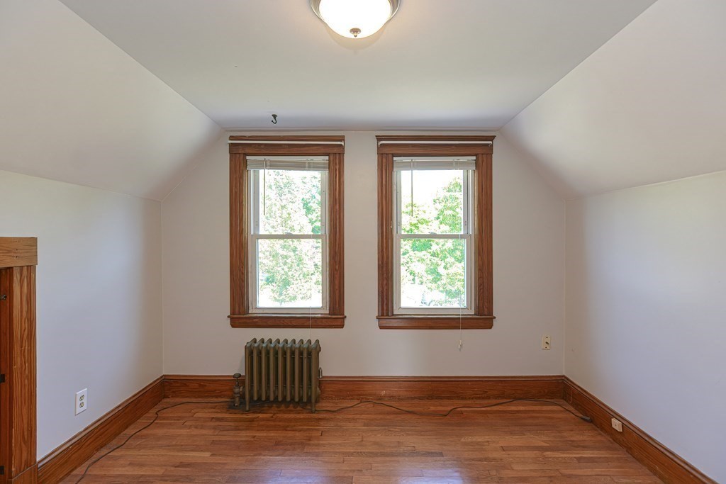 228 Pond Street Natick, MA 01760 - Photo 26 of 36 an empty room with wooden floor and windows