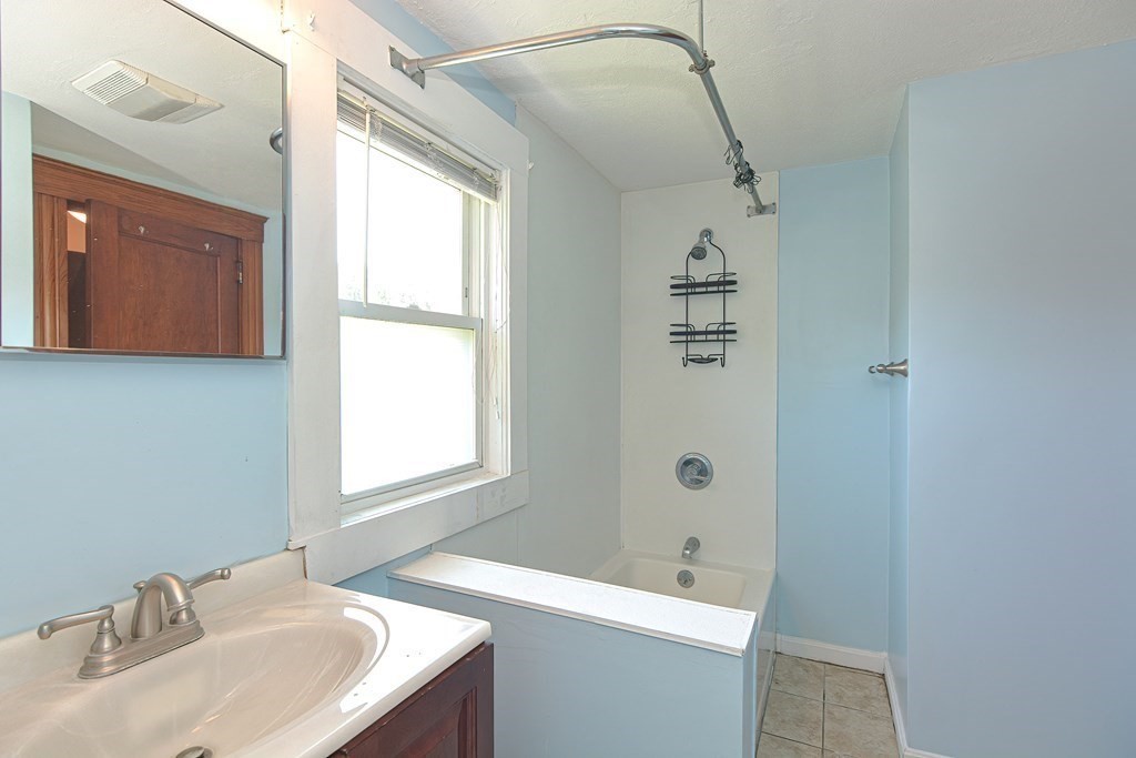 228 Pond Street Natick, MA 01760 - Photo 29 of 36 a bathroom with a sink a toilet and shower