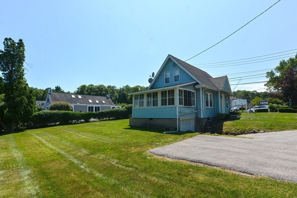 228 Pond Street Natick, MA 01760 - Photo 34 of 36 a front view of a house with a garden