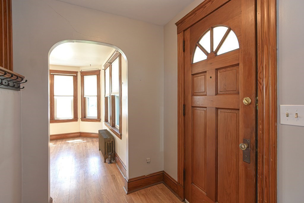 228 Pond Street Natick, MA 01760 - Photo 6 of 36 a view of a hallway with wooden floor and windows