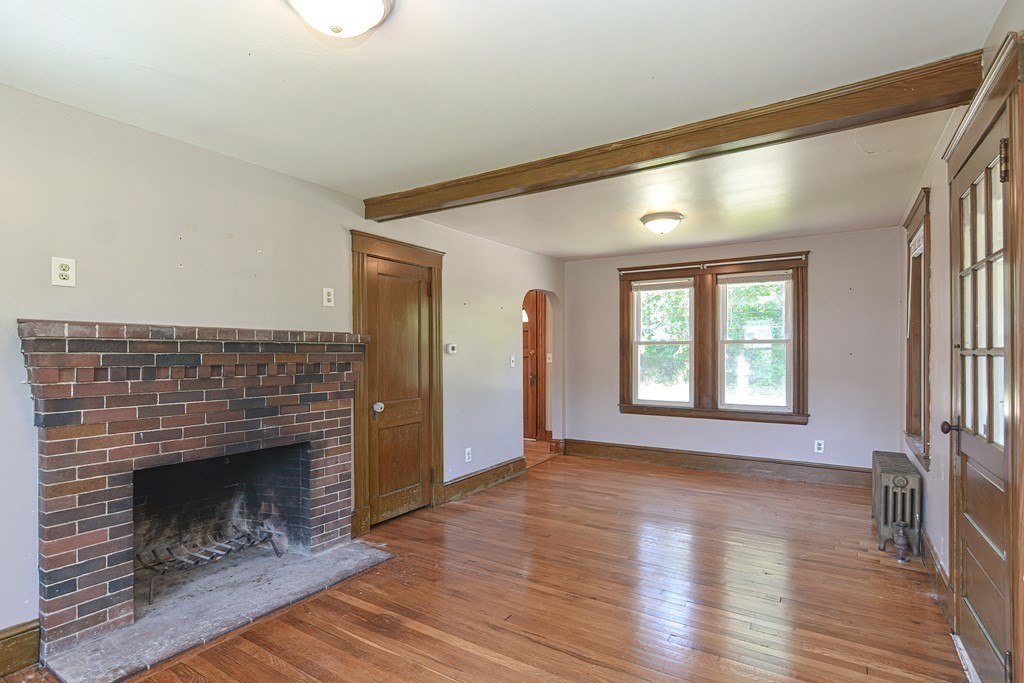 228 Pond Street Natick, MA 01760 - Photo 7 of 36 a living room with a fireplace and wooden floor