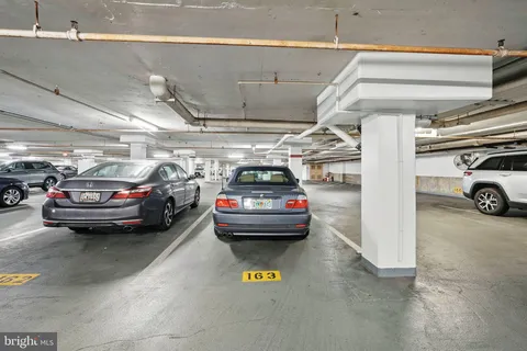 a view of parking garage with cars parked