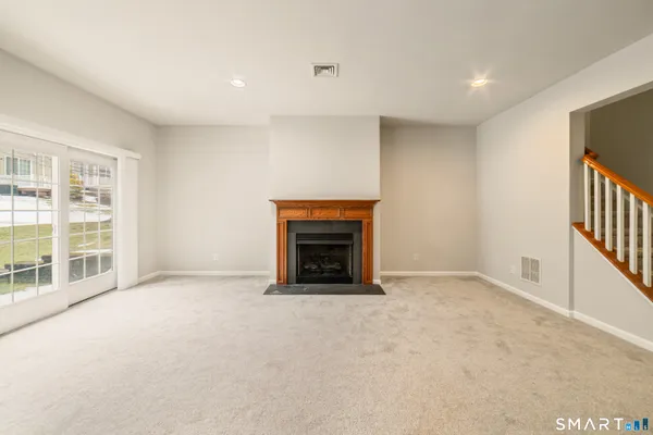 a view of an empty room with a fireplace