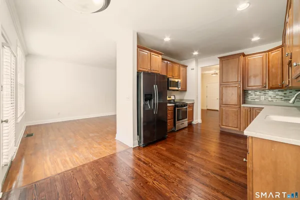 a kitchen with stainless steel appliances a refrigerator and a stove top oven