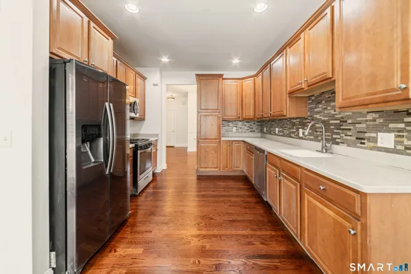 a kitchen with stainless steel appliances a sink and a refrigerator