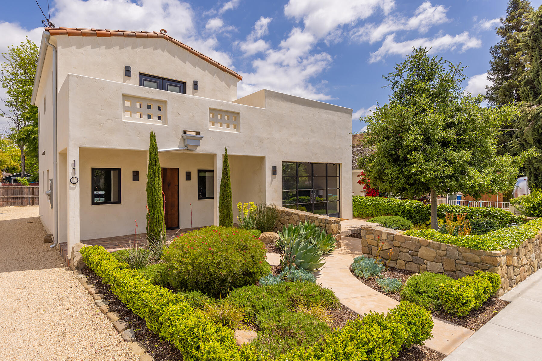 a front view of a house with garden