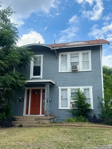 a view of house with yard in front of it