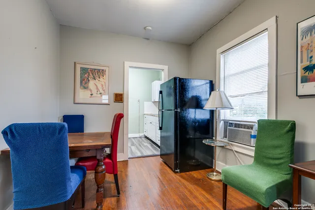 a living room with furniture wooden floor and a window