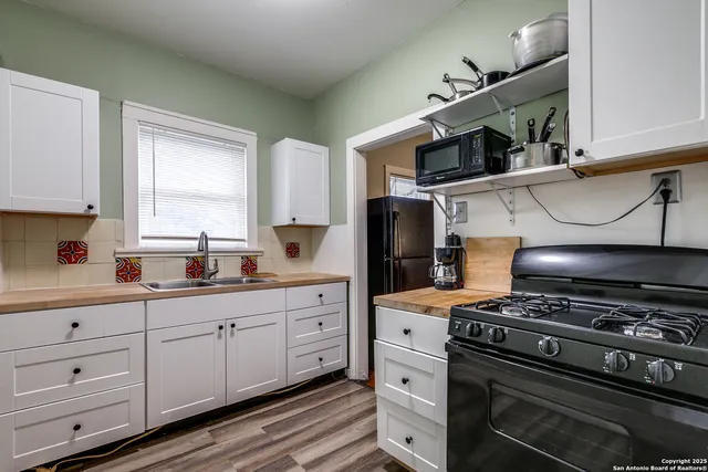 a kitchen with stainless steel appliances a stove a sink and a cabinets