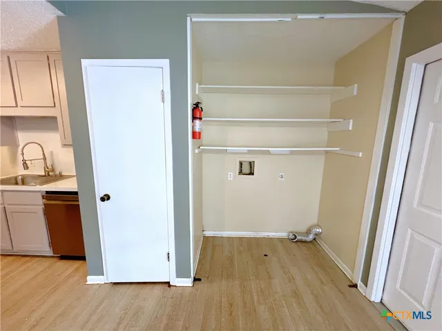 a view of a room with wooden floor and cabinet