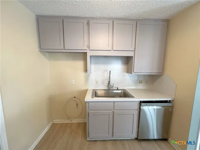 a kitchen with a sink cabinets and window