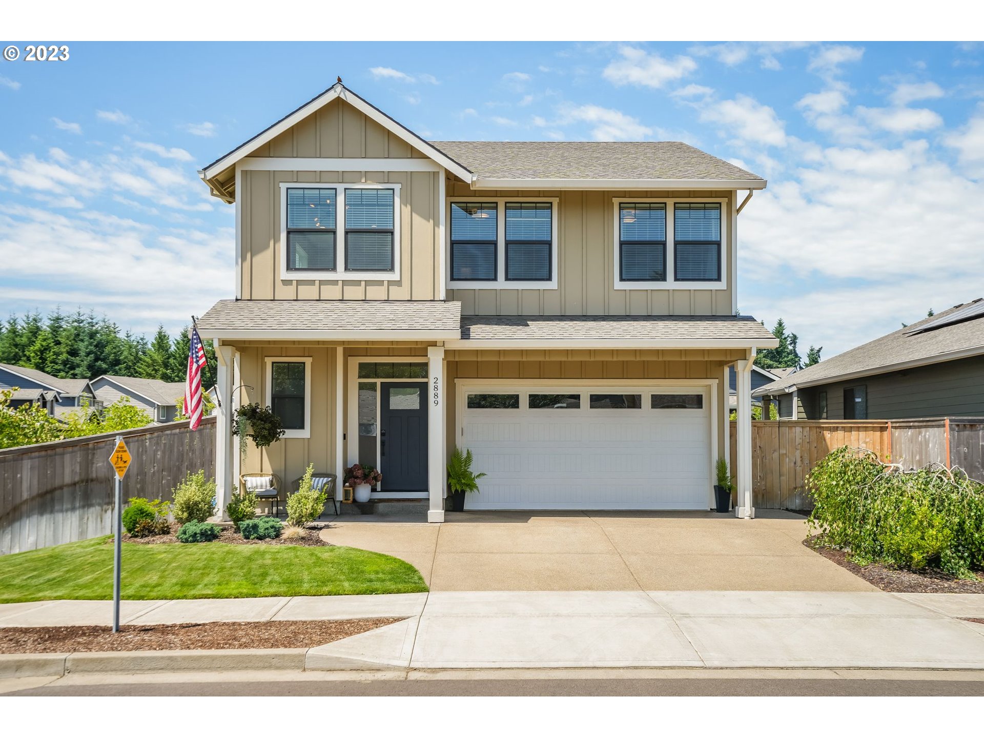 a front view of a house with a yard and garage