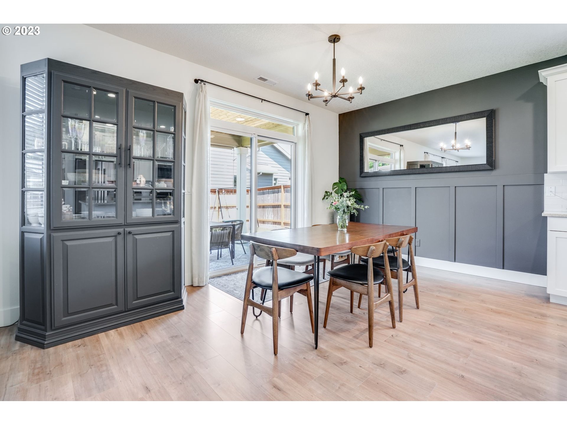 2889 4th Street Hubbard, OR 97032 - Photo 13 of 37 a dining room with furniture a chandelier and wooden floor