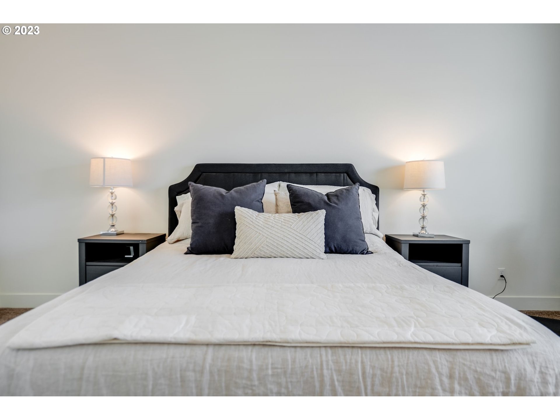 2889 4th Street Hubbard, OR 97032 - Photo 17 of 37 a bedroom with a bed and a night stand