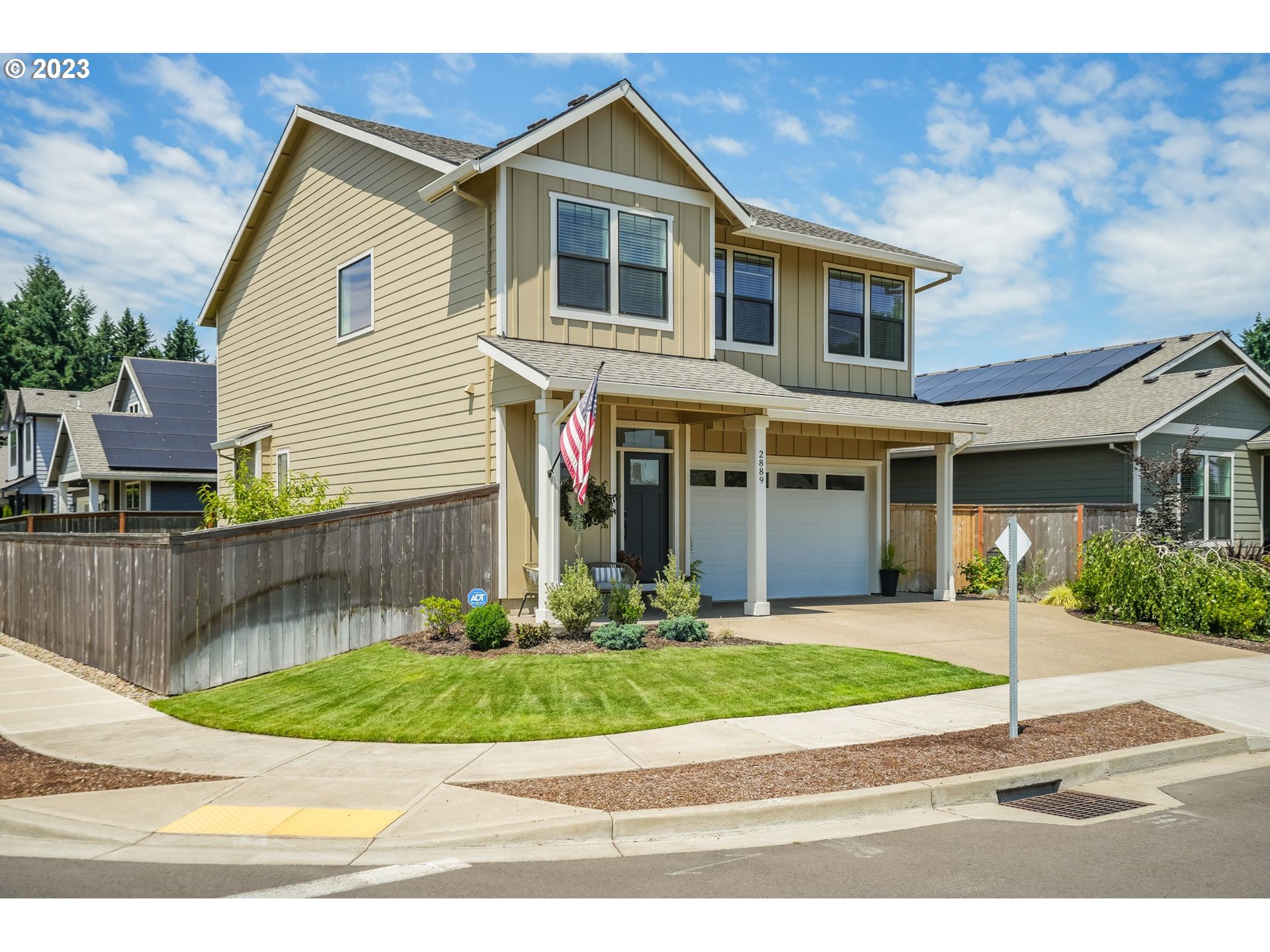 2889 4th Street Hubbard, OR 97032 - Photo 34 of 37 a front view of a house with a yard and potted plants