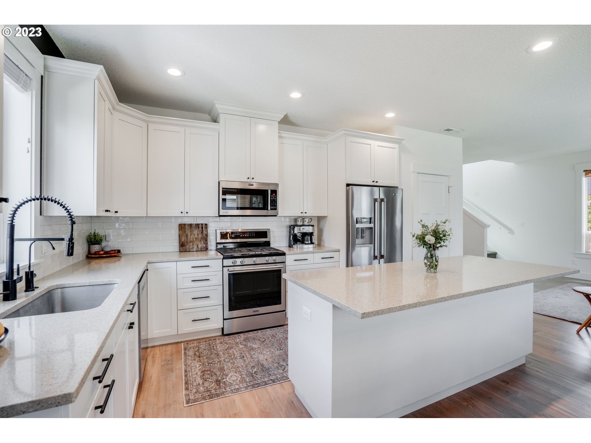 2889 4th Street Hubbard, OR 97032 - Photo 9 of 37 a kitchen with stainless steel appliances a sink a stove a refrigerator cabinets and a window