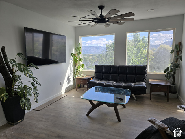 1397 Ritter Drive Riverdale, UT 84405 - Photo 6 of 21 Expansive windows with mountain scenery, wood-finish flooring, and a ceiling fan