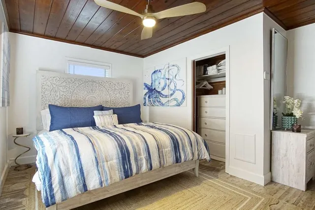 a large bed sitting in a bedroom next to a window