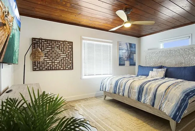 a bedroom with a bed and a night stand