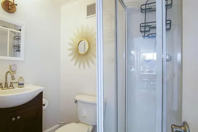 a bathroom with a toilet and a shower