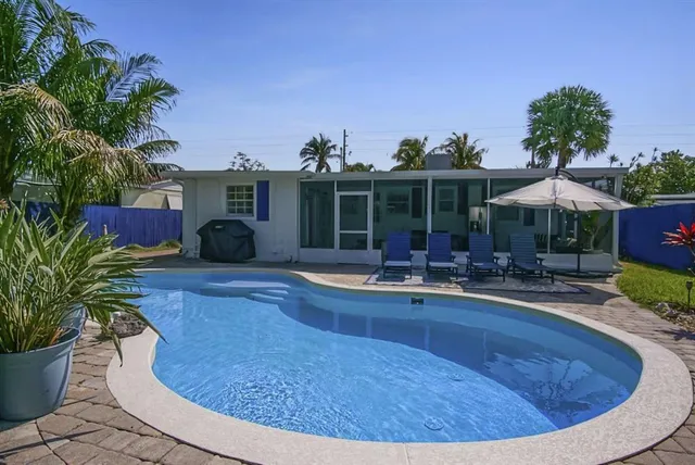a backyard of a house with outdoor seating
