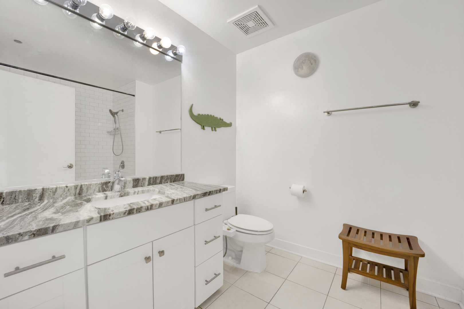 833 West 15th Place, Unit 511 Chicago, IL 60608 - Photo 13 of 21 a spacious bathroom with a granite countertop sink a toilet and a mirror
