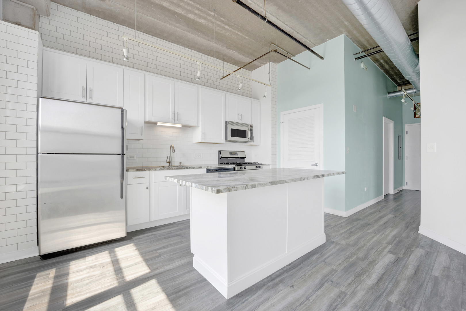 833 West 15th Place, Unit 511 Chicago, IL 60608 - Photo 6 of 21 a kitchen with granite countertop a refrigerator and a stove top oven
