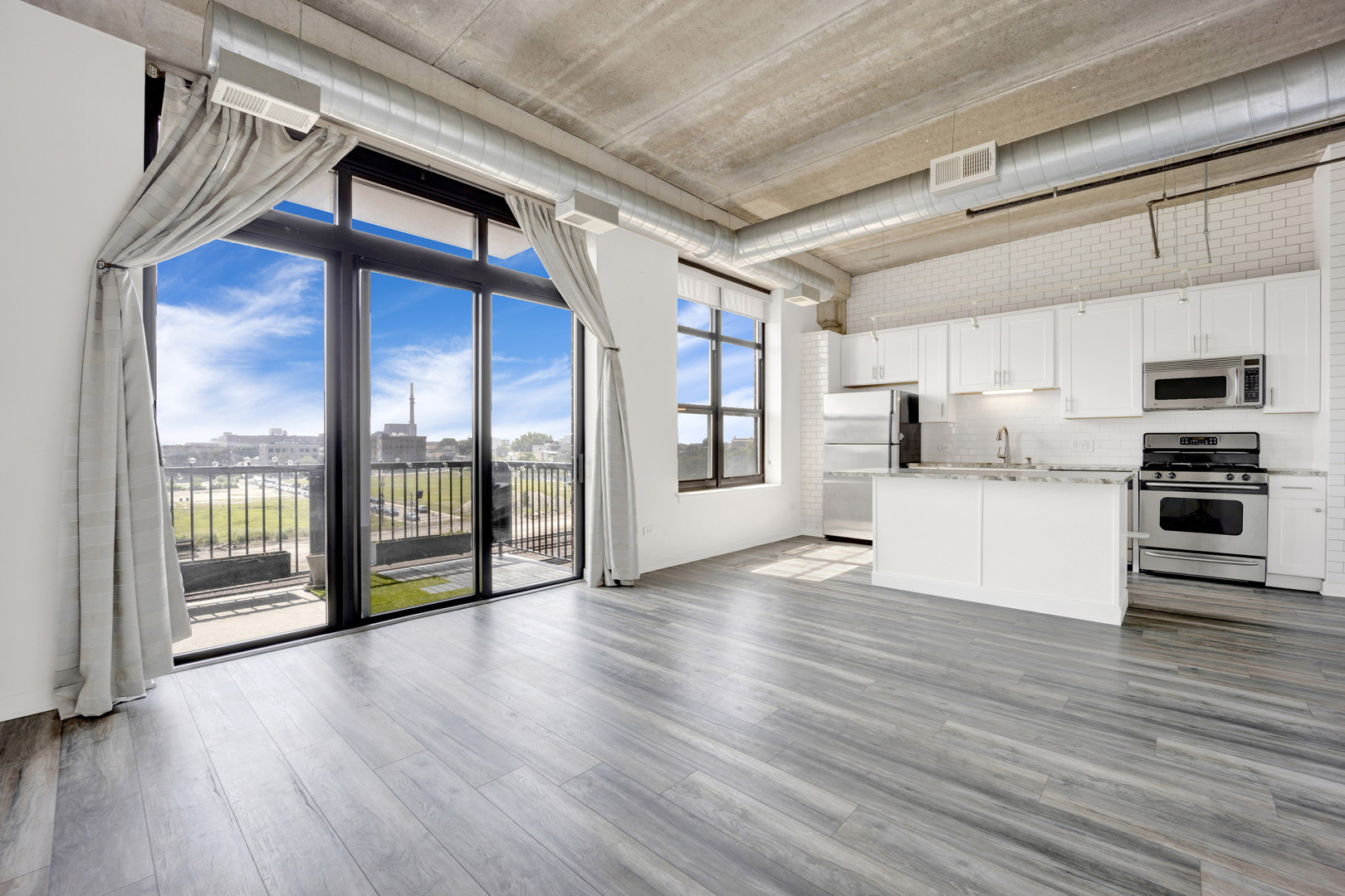 833 West 15th Place, Unit 511 Chicago, IL 60608 - Photo 10 of 21 a view of kitchen with stainless steel appliances wooden floor and a large window
