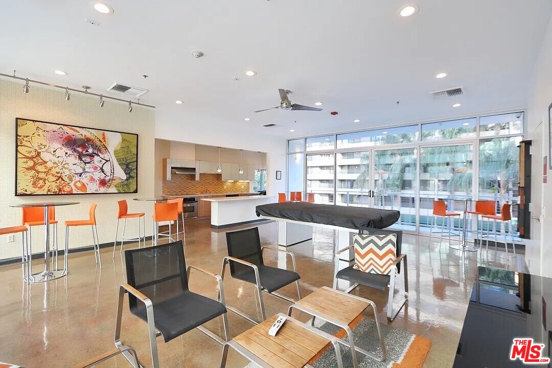 645 West 9th Street, Unit 240 Los Angeles, CA 90015 - Photo 15 of 25 a living room with lots of furniture and a painting on the wall