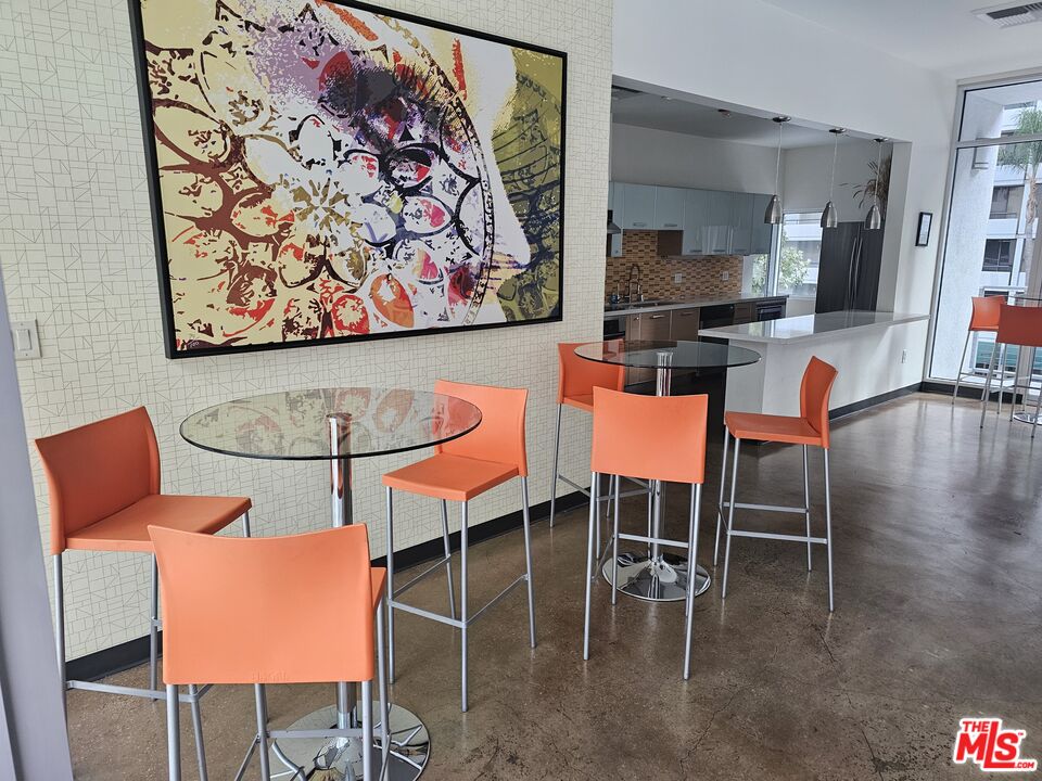 645 West 9th Street, Unit 240 Los Angeles, CA 90015 - Photo 17 of 25 a dining room with wooden floor and breakfast area