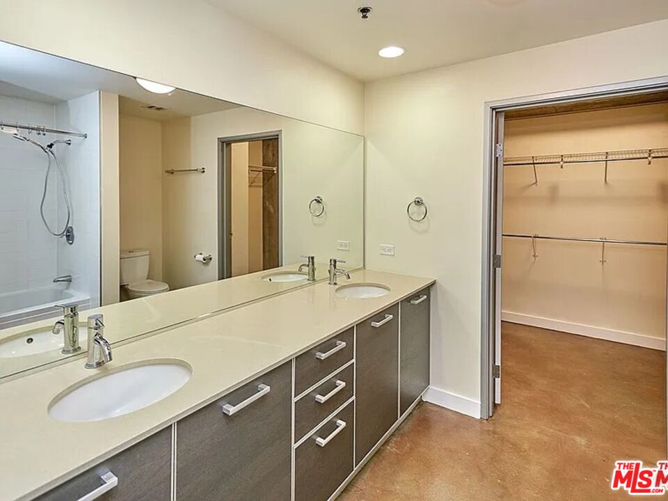 645 West 9th Street, Unit 240 Los Angeles, CA 90015 - Photo 24 of 25 a spacious bathroom with a granite countertop sink mirror and double